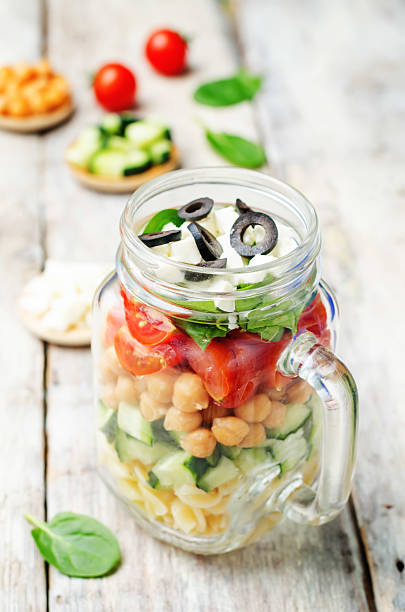 istock Pasta chickpeas cucumber tomatoes spinach goat cheese salad 515196446