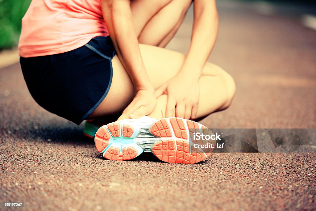 sports  injury Runner athlete got a pain iwth twisted ankle Adult Stock Photo