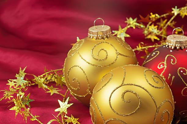 istock Two golden and one red christmas bulbs 515197577