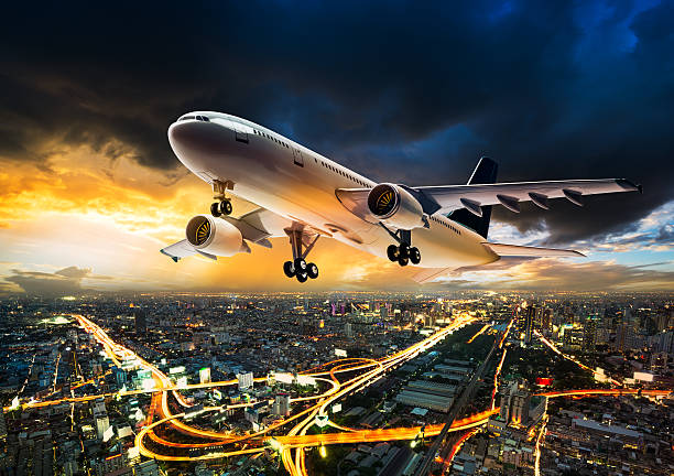 istock Airplane over night scene city 515197982