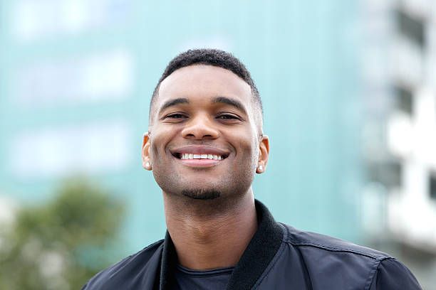 istock Friendly young man smiling outdoors 515199539