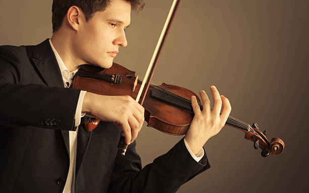 istock Man violinist playing violin. Classical music art 515199579