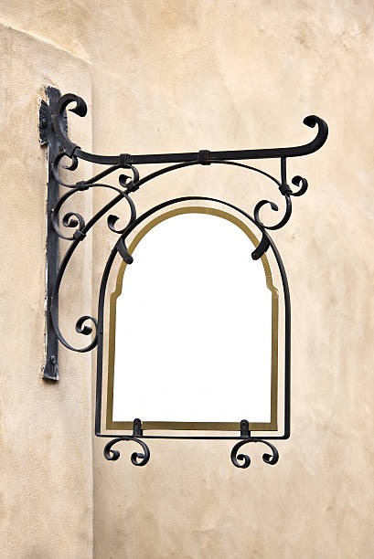 Blank wrought iron old sign hanging on a wall
