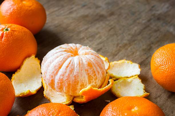 istock mandarins lie on a wooden table 515202284
