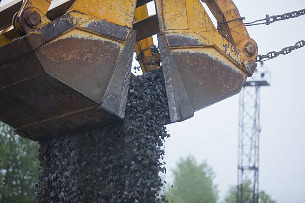 istock Heavy excavator and bulldozer unloading road metal during road work 515203389