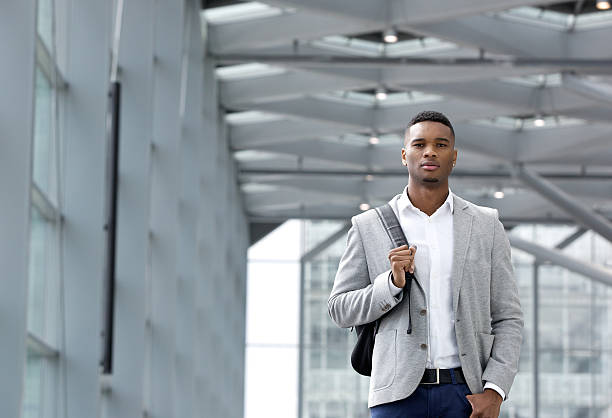istock Cool young man walking inside station building with bag 515203841