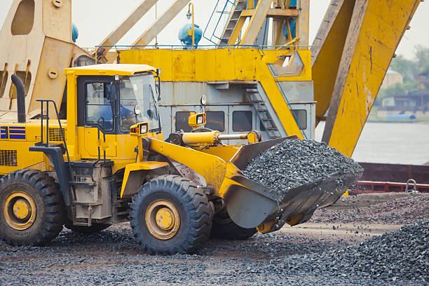 istock Heavy excavator and bulldozer unloading road metal during road work 515219411