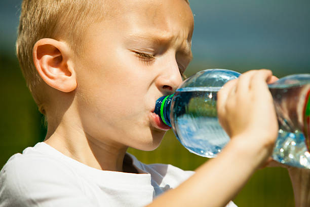 istock Little boy drink water from bottle, outdoor 515219727
