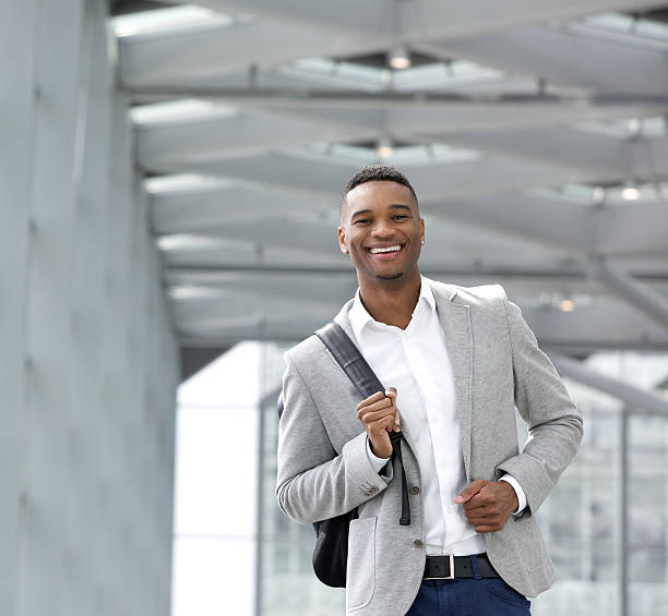 istock Cheerful young man walking at airport with bag 515219751