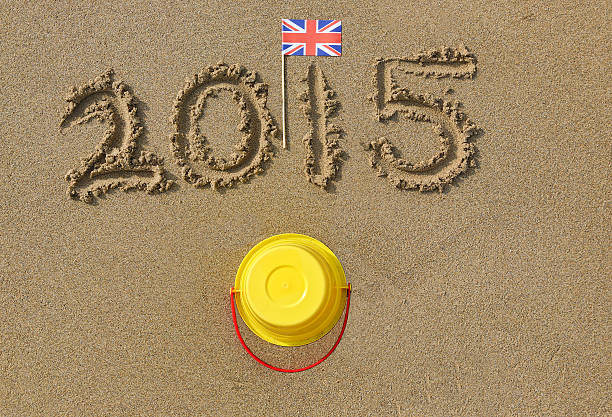 istock Beach with yellow bucket union jack flag and 2015 515220237