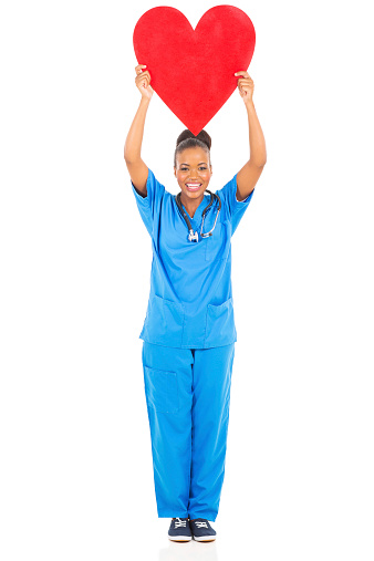 cheerful african american female doctor holding heart on white background