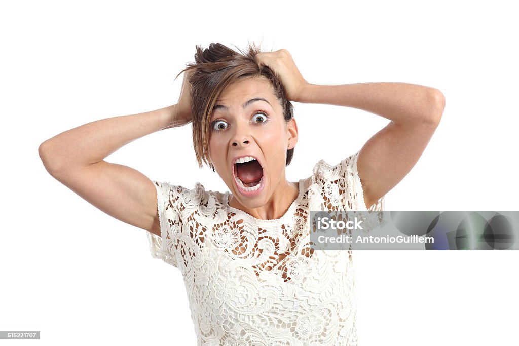 Scared woman screaming with hands on head Front view of a scared woman screaming with hands on head isolated on a white background Hysteria Stock Photo