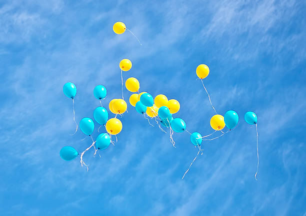 istock Yellow and blue balloons flying up 515221741
