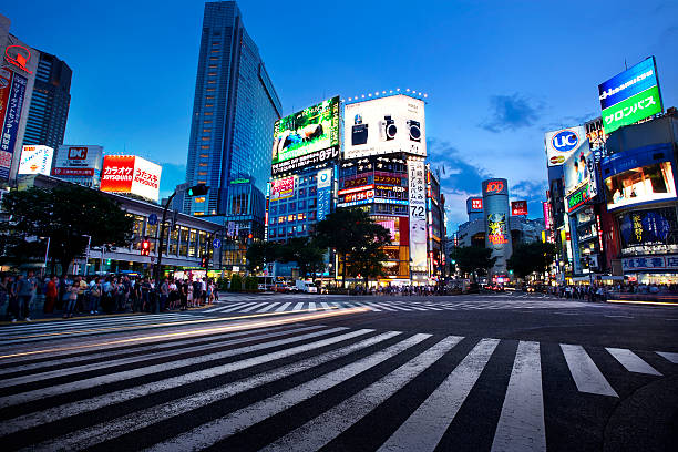 Shibuya Crossing Wide angle shot of Shibuya crossing at dusk. shibuya district stock pictures, royalty-free photos & images