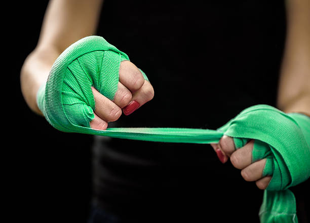 istock Woman is wrapping hands with green boxing wraps 515222522