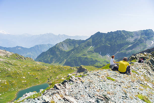 istock Hikers resting on the mountain summit, expansive panorama 515222902