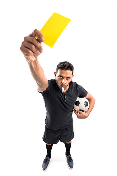 Yellow card Football referee whistling and showing yellow card, view from above foul stock pictures, royalty-free photos & images