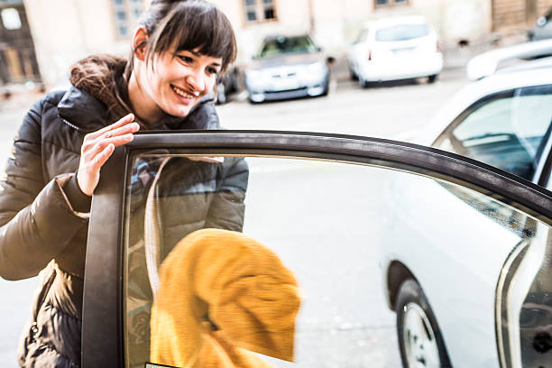 istock Young Joyful Woman Cleaning Car Windows 515224356