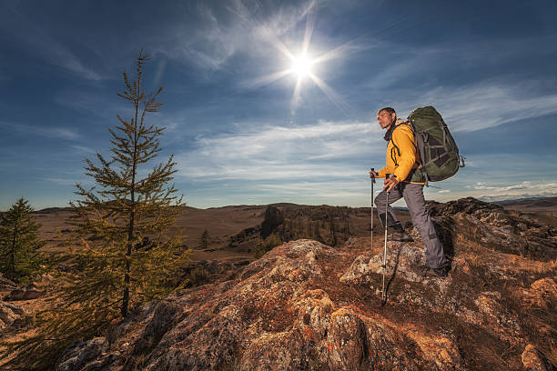istock Backpacker on a high rock and looking at the distance 515224612