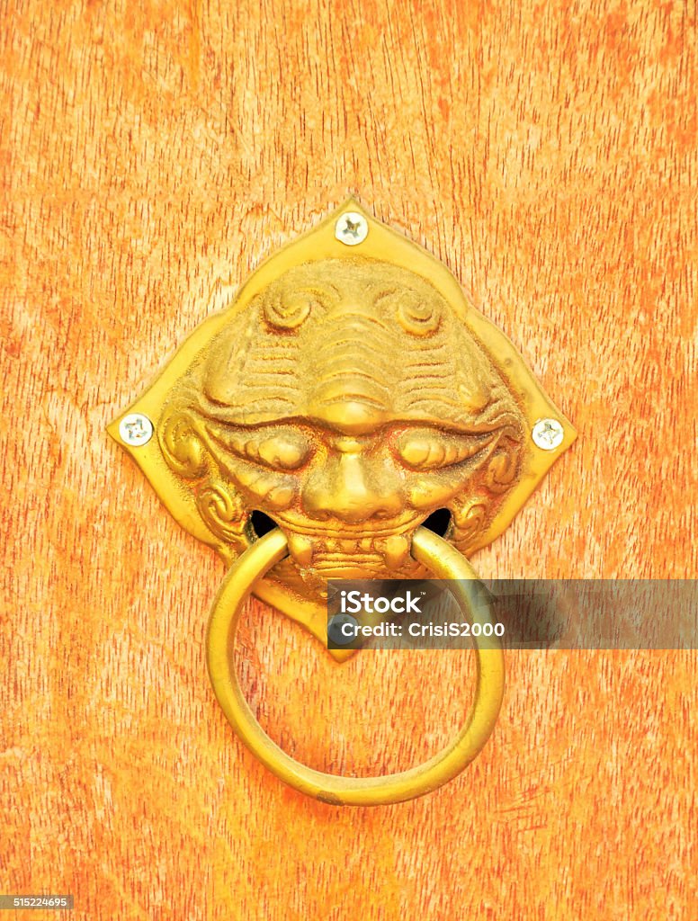 Lion face door knocker made ââof brass. Lion face door knocker made ââof brass. Used to decorate the house looks strange. Animal Body Part Stock Photo