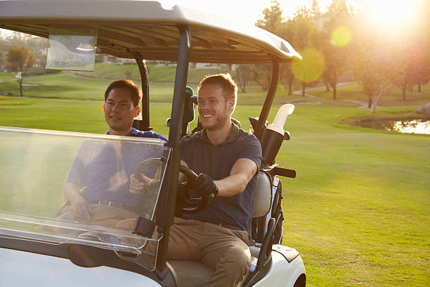 istock Male Golfers Driving Buggy Along Fairway Of Golf Course 515229752