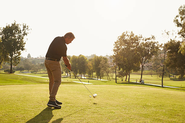 istock Male Golfer Lining Up Tee Shot On Golf Course 515229972