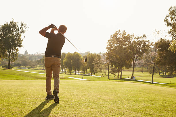 istock Male Golfer Lining Up Tee Shot On Golf Course 515230126