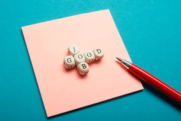 Photo of GOOD JOB text on a wooden cubes