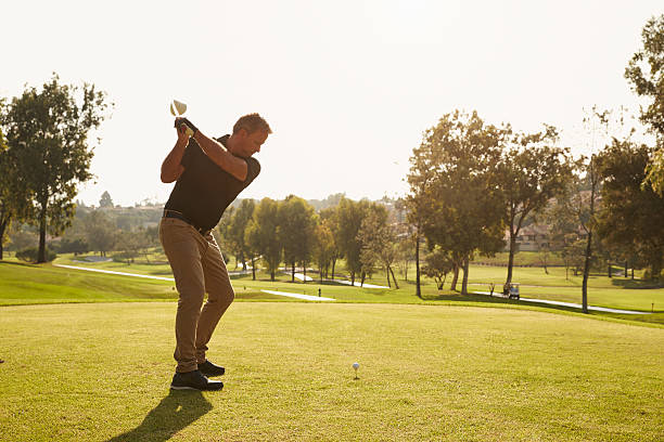 istock Male Golfer Lining Up Tee Shot On Golf Course 515230146
