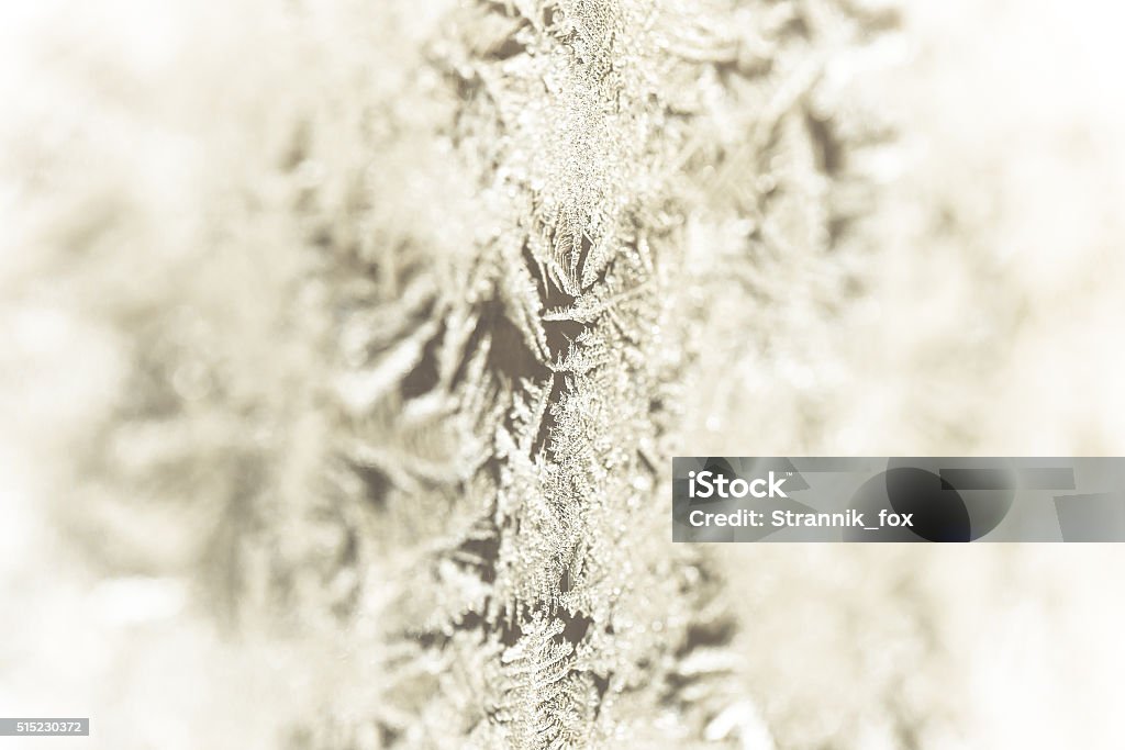 Frozen patterns on a window. Winter nature background. Selective Frozen patterns on a window. Winter nature background. Selective focus. Toned. Abstract Stock Photo