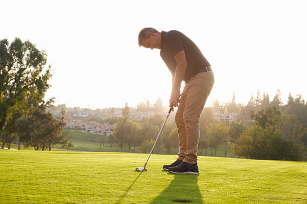 istock Male Golfer Lining Up Putt On Green 515230628