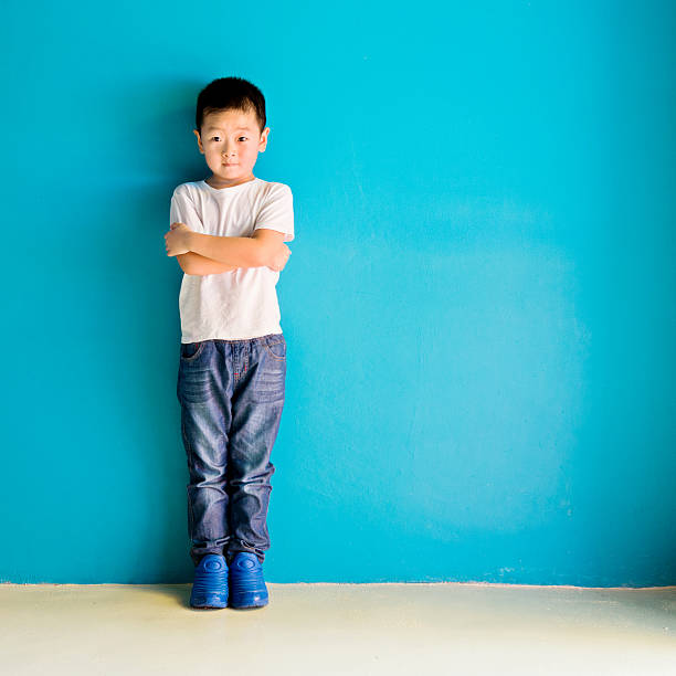 istock Chinese little boy against wall 515232064