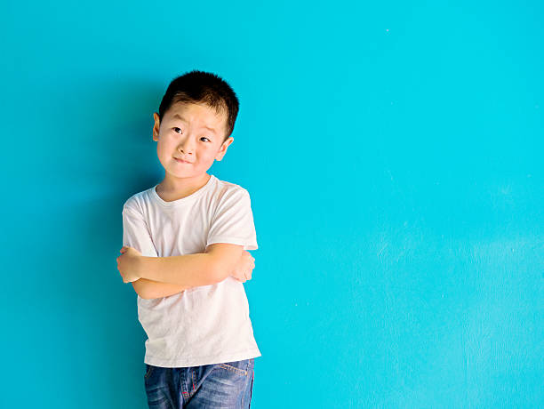 istock Chinese little boy against wall 515232594