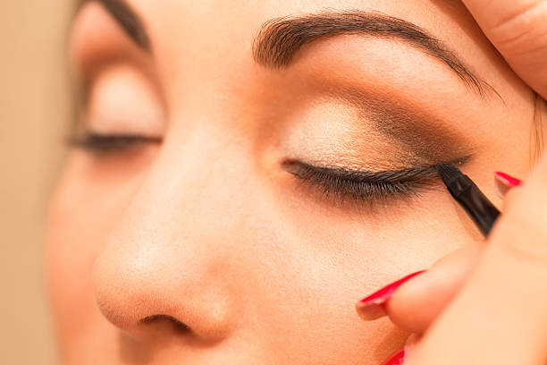 istock Applying makeup, eyeliner on a beautiful age-related woman face. 515233244