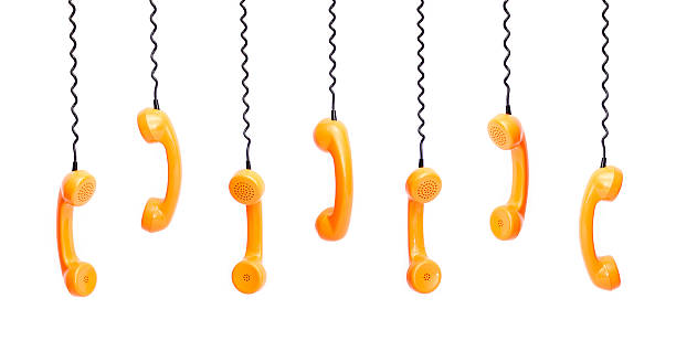 istock Handset piece from an old phone suspended by phone cord 515234400