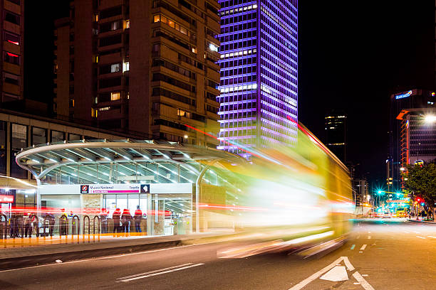 Bogota, Colombia - January 10, 2015: TransMilenio bus passing through a special, dedicated lane reserved for the bus system. People can be seen walking by the streets.