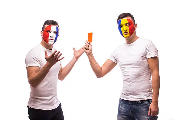 France vs Romania. Open match Euro 2016.Football fan of  Romania national teams show red card to France fan on white background. UEFA EURO 2016 football fans concept.
