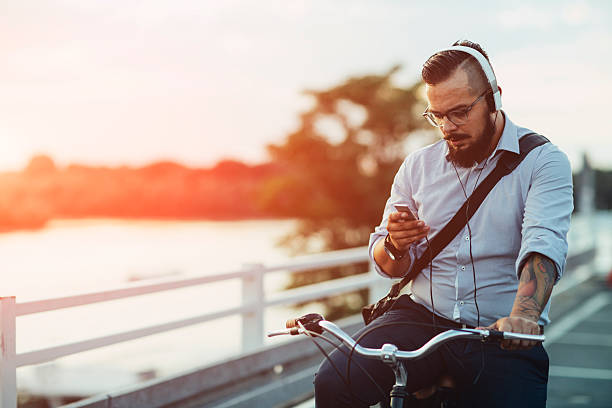 istock Businessman Sitting On Bicycle And Using Smartphone Outdoors. 515236764