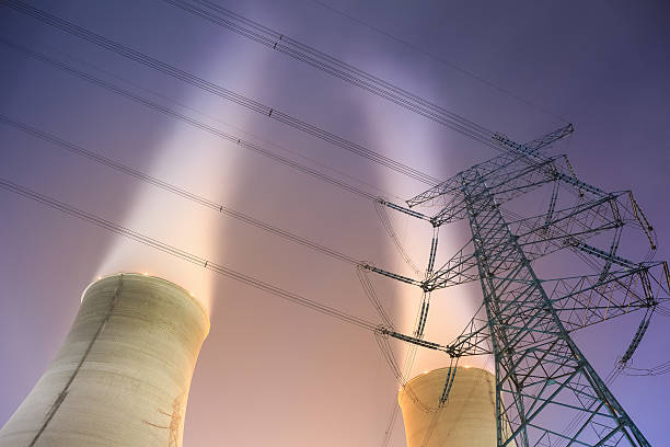 istock cooling towers and power transmission tower 515246783