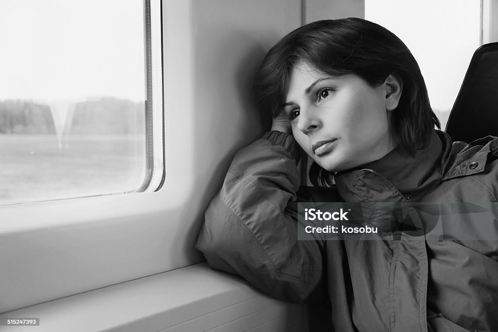 Young woman traveling by train Young woman is traveling by train, looking to the window 30-39 Years Stock Photo