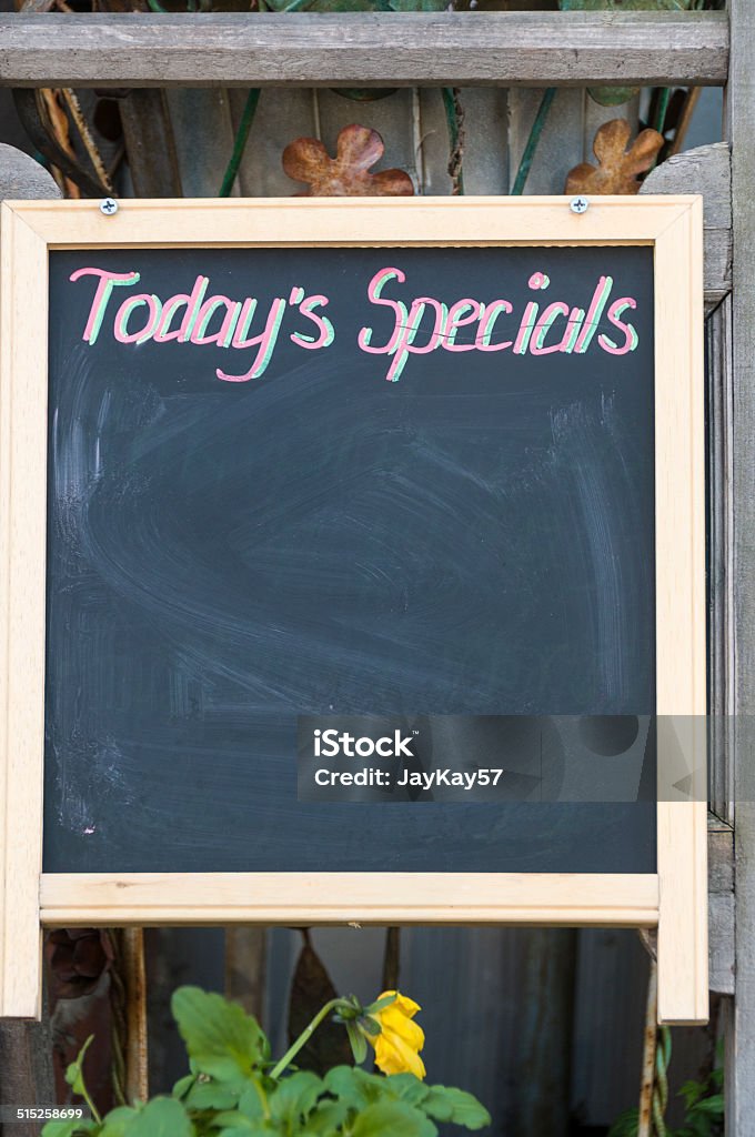 Today's Specials Wooden blackboard outside an outdoor cafe with room for copy space.   Cafe Stock Photo