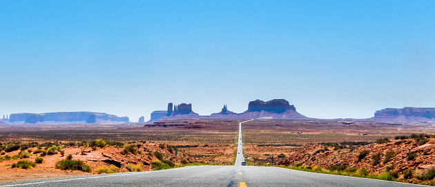 Low shot from the road looking towards Monument Valley