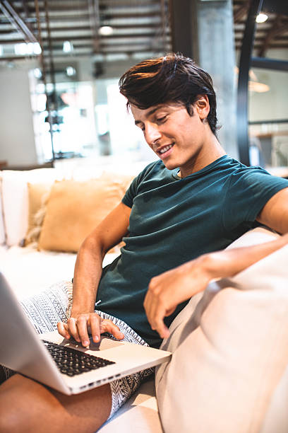 istock Cheerful man relaxing online on sofa 515259935