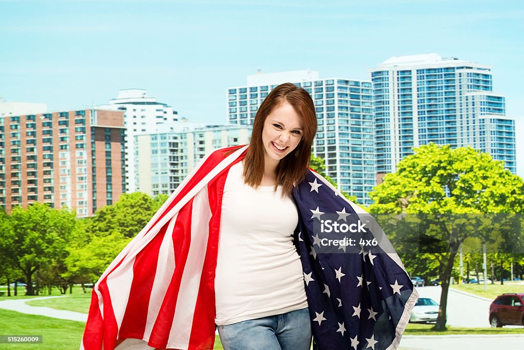 Happy female outdoors with American flag Happy female outdoors with American flaghttp://www.twodozendesign.info/i/1.png 20-24 Years Stock Photo