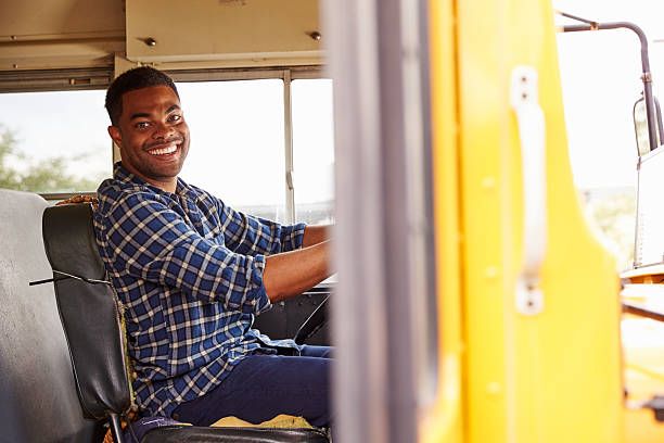 uśmiechająca się autobus szkolny kierowca siedzi w autobus - school bus education transportation school zdjęcia i obrazy z banku zdjęć