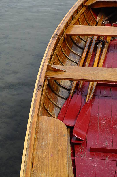 istock Wooden small boat and red paddles 515263315