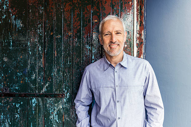 istock Confident businessman standing against wooden wall 515263388