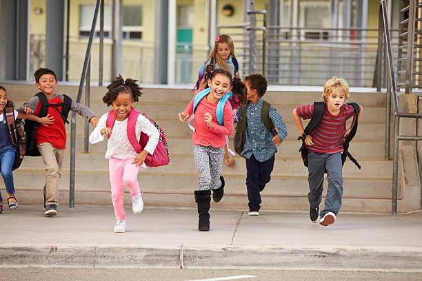 istock A group of elementary school kids rushing out of school 515263540