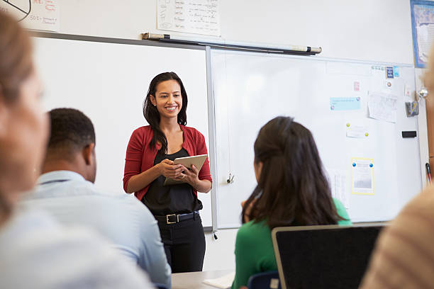 istock Teacher with tablet and students at an adult education class 515263784