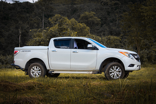 Nan, Thailand - October 30, 2014: Mazda BT-50 against meadows, Mazda BT-50 is a Japan car manufacturer specializing in four-wheel drive vehicles.